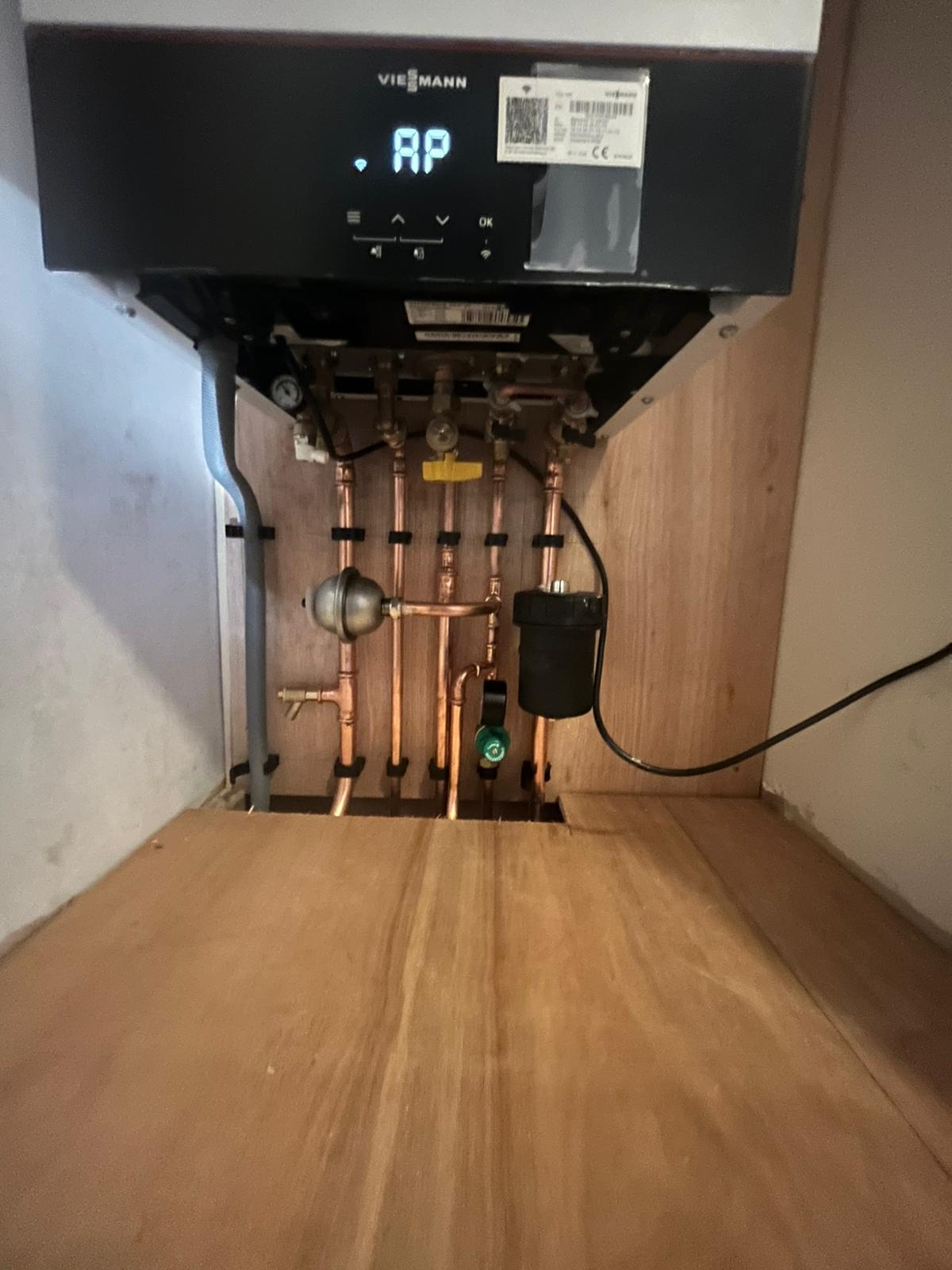 Viessmann boiler underside showing copper pipework and magnetic system filter